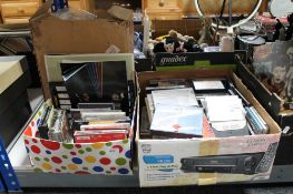 Two boxes of CD's and cassette tapes together with a Kovac print out calculator