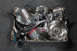 A box of kitchen sauce pans, frying pans,