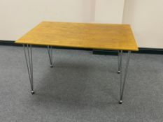 A contemporary dining table on hairpin legs