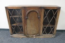An Edwardian oak triple door bookcase