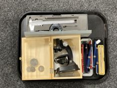 A tray of a various pens, precision instrument in case, microscope in box,