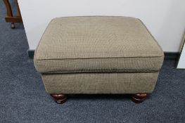 An upholstered footstool