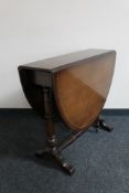 An inlaid mahogany Regency style drop leaf table