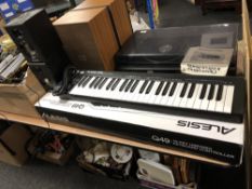 A boxed Alesis Q49 USB keyboard and pair of Alesis speakers