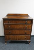 An Edwardian walnut four drawer chest on Queen Anne style legs