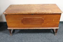 An antique pine blanket chest on raised legs