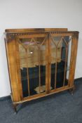A 1930's walnut double door display cabinet