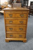 A burr yew veneered audio cabinet in the form of a four drawer chest.
