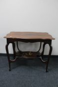 A shaped Edwardian two tier occasional table.