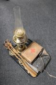 A tray of horse brasses on leather, goats head shoe horns, antique Duplex oil lamp and chimney,