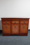A mahogany effect triple door sideboard.