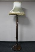 A stained beech standard lamp and shade.