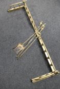 A Victorian brass fire curb together with two brass companion pieces