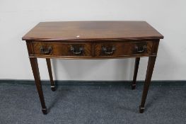 A 20th century mahogany bow-fronted console table.