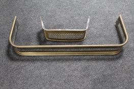 An antique brass fire curb and a brass fire front.