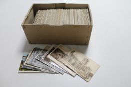 A box of antique and later postcards;