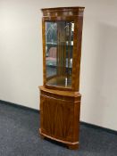 A yew wood corner display cabinet