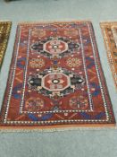 An Afghan Bokhara rug on rust ground,