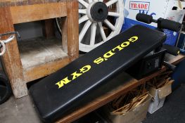 A gold gym sit-up bench together with a digital safe