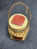 A wicker bound middle eastern style storage container