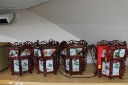 Four wooden Chinese style lantern light fittings with glass panels (a/f)
