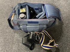 A camera bag containing Olympus OM10 camera,