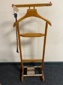 A mid century valet stand together with a tie master roller and shoe horn with jockey head handle