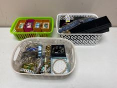 A tray of three baskets of bangles, bracelets,