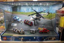A Lego City 60138 and 60137 sets in shop display case