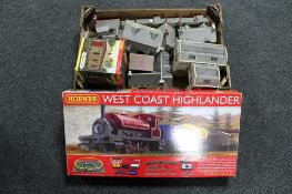A boxed Hornby West Coast Highlander 00 gauge train set together with a further box of buildings