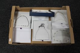A box of five costume necklaces
