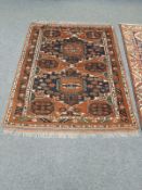 An Afghan Bokhara rug on rust ground,