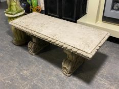 A concrete pedestal garden bench