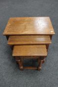 A nest of three oak tables