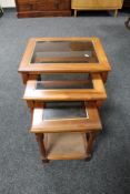 A nest of three mahogany glass topped tables