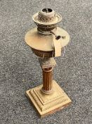 An antique brass Corinthian column oil lamp