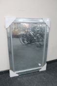 A contemporary all glass framed bevelled edge mirror