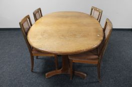 A mid 20th century oval teak G Plan extending table with shaped under stretcher,