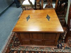 A contemporary hardwood storage chest with hinged top,