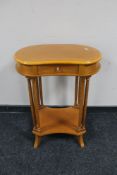 A kidney shaped occasional table fitted a drawer