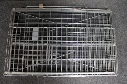 A folding metal dog cage