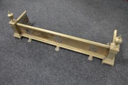 An Art Nouveau brass fire curb on paw feet