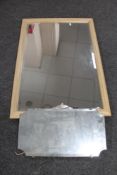 A 1930's frameless bevelled mirror together with as further framed bevelled overmantel mirror