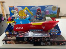 A Paw Patrol sea patrol boat and three Star Wars The Force Awakens action figures