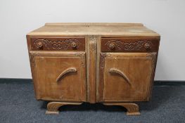 An early 20th century carved oak sideboard