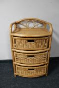 A bamboo and wicker three drawer chest