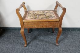 An early 20th century storage piano stool