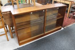 A set of mid century teak sliding glass door bookshelves