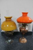 A brass oil lamp with orange glass shade and chimney together with an Aladdin chrome oil lamp and