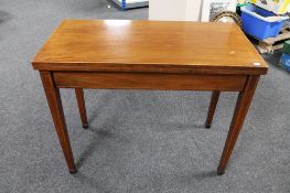 A 19th century inlaid mahogany turn over top tea table